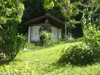 a small chapel in the middle of a grassy field at Balkanski chanove in Botevgrad