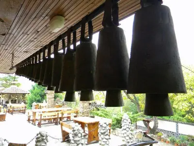 a row of black lights hanging from a roof at Balkanski chanove in Botevgrad