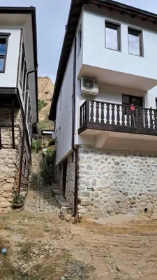 a building with a balcony on the side of it at Apartment R. Dermendzhiev in Melnik