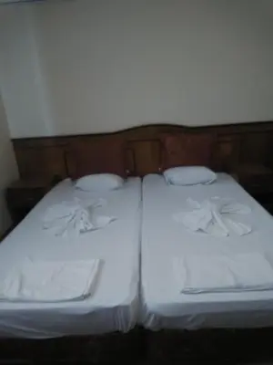 two twin beds with white sheets and pillows at Guest House Nani in Asenovgrad