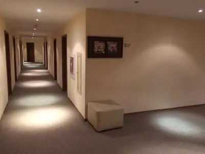 an empty hallway with a bench in a building at Enjoy Studios and Lovely Apartment Villa Park in Borovets