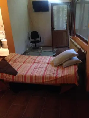 a bed with pillows on it in a room at Hotel- Restaurant Struma in Stara Kresna
