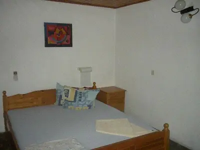 a small bedroom with a bed and a picture on the wall at Hotel- Restaurant Struma in Stara Kresna