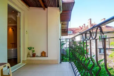 a balcony of a house with a view of a bathroom at Portofino Apartment in Sofia