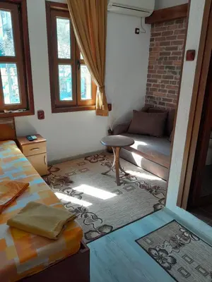 a living room with a bed and a couch at Mario Complex in Melnik