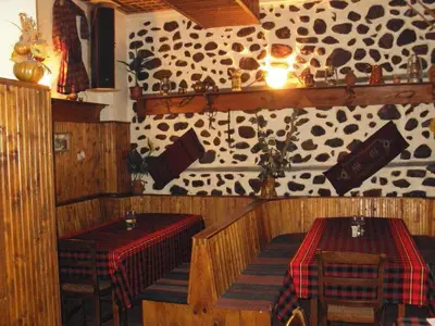 a dining room with two tables and a patterned wall at Mario Complex in Melnik