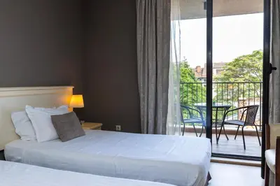 a hotel room with a bed and a balcony at St. George Hotel in Sofia