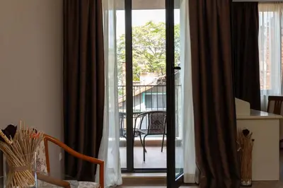 a room with a sliding glass door to a balcony at St. George Hotel in Sofia