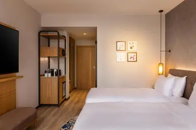 a hotel room with two beds and a flat screen tv at Hyatt Regency Pravets Resort in Pravets