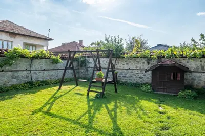 a chair sitting in the grass in a yard at Chalet White Fang in Bansko
