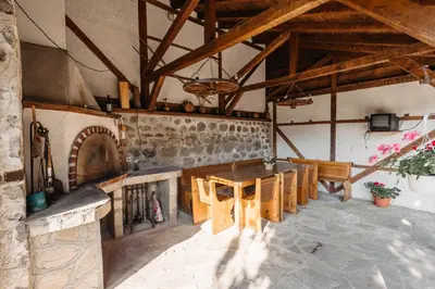 a dining room with a table and a fireplace at Chalet White Fang in Bansko