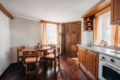 a kitchen with a table and chairs and a sink at Chalet White Fang in Bansko