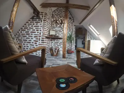 a living room with two chairs and a table at Gramophone Sofia Downtown Apartment in Sofia