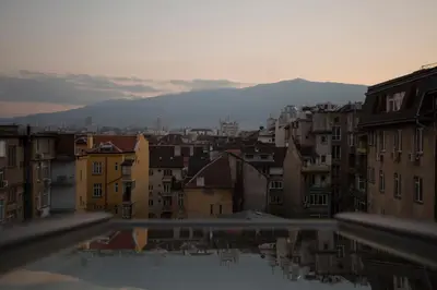 a view of a city with buildings and mountains at Gramophone Sofia Downtown Apartment in Sofia