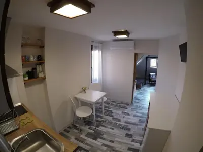 a bathroom with a sink and a table and a counter at Gramophone Sofia Downtown Apartment in Sofia