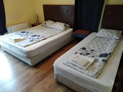 two beds in a hotel room with at Fenix Family Hotel in Blagoevgrad