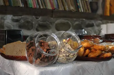 a table topped with three glass containers filled with food at Старата Тонина къща in Dobrinishte