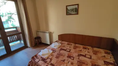 a bedroom with a bed and a large window at Medic Hotel in Sofia