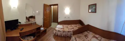 a living room with a table and a television at Medic Hotel in Sofia