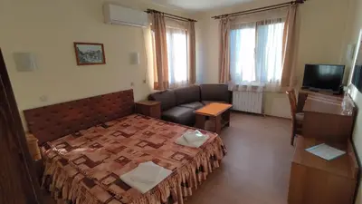 a living room with a bed and a couch at Medic Hotel in Sofia