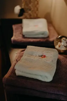 two towels sitting on a counter in a bathroom at City Center Stylish 3 Bedroom Apartment in Sofia