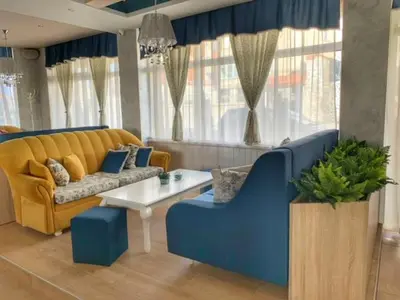 a living room with a couch and a table at The Secret Garden in Ognyanovo