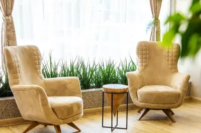 two chairs and a table in front of a window at City Avenue Hotel in Sofia
