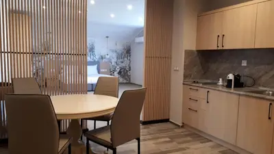 a kitchen and dining room with a table and chairs at Tsarsko Selo Spa Hotel in Sofia