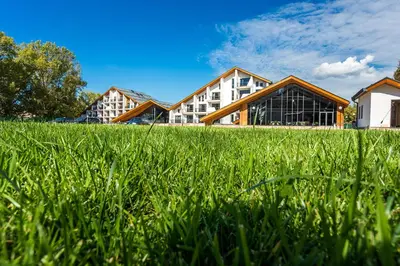 a row of buildings in a field of grass at Park Hotel Asarel in Panagyurishte