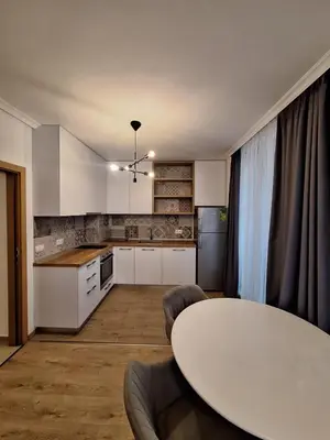 a kitchen with a white table and a white table at Apartments Mladost 1A in Sofia