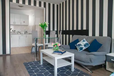 a living room with a couch and a table at Sofia Central Hotel Apartments in Sofia