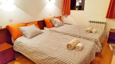 two beds in a small room with towels on them at Bansko front door to the Gondola and town centre in Bansko