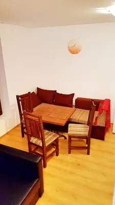 a living room with a couch and a table and chairs at Bansko front door to the Gondola and town centre in Bansko