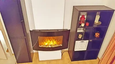 a fireplace in the corner of a room at Bansko front door to the Gondola and town centre in Bansko
