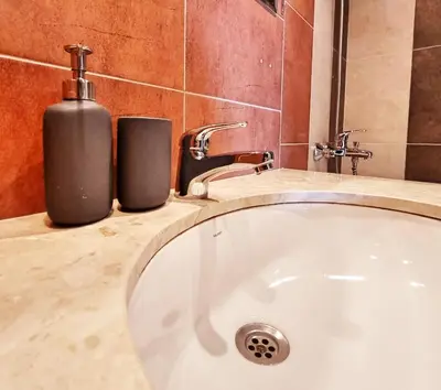 a bathroom with a bath tub and a soap dispenser at Bansko front door to the Gondola and town centre in Bansko