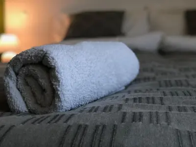 a towel sitting on top of a bed at Terra Guest House in Velingrad