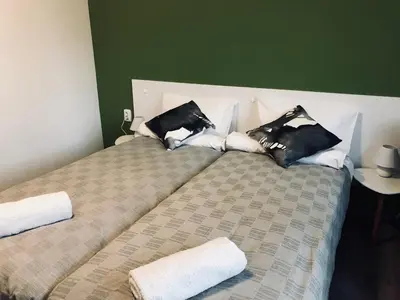 a bed with pillows on it in a room at Terra Guest House in Velingrad
