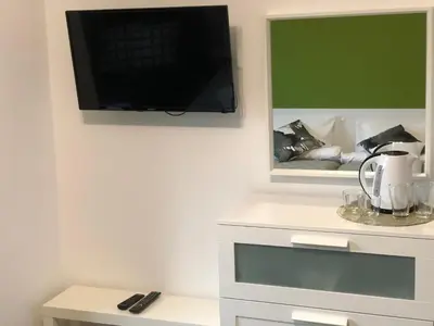 a living room with a tv on a wall at Terra Guest House in Velingrad