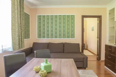a living room with a couch and a table at Apartments in Complex Grand Manastira in Pamporovo