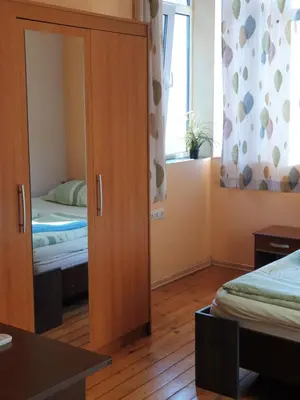 a bedroom with a cupboard and a bed and a window at Elegance on a Budget - Rooms for Rent in Sofia Center in Sofia