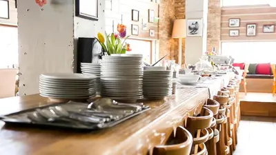 a long table with plates and utensils on it at White Lavina - Ski, Bike, Hike in Bansko