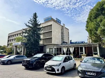 a group of cars parked in front of a building at Hotel Forum - Free Parking for cars in Sofia