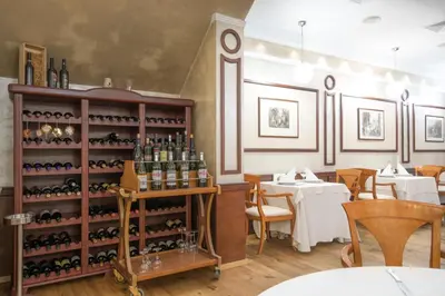 a restaurant with a shelf of wine bottles at Hotel Downtown in Sofia
