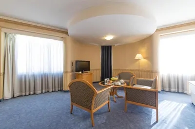 a hotel room with a table and chairs at Hotel Downtown in Sofia