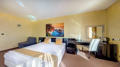 a hotel room with a bed and a desk at Europe Hotel in Sofia