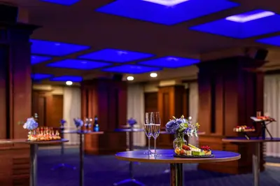 a room with tables with wine glasses and blue lights at Grand Hotel Sofia in Sofia