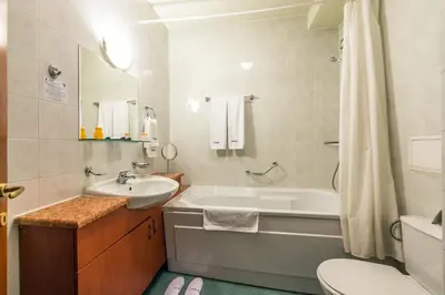 a bathroom with a tub and a sink and a toilet at Sveta Sofia Hotel in Sofia