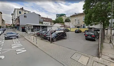 a street with cars parked in a parking lot at Hotel Lion Sofia in Sofia