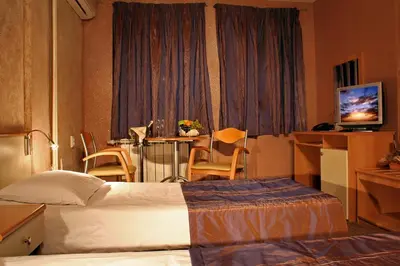 a hotel room with a bed and a table at Hotel Brod - Free Parking in Sofia