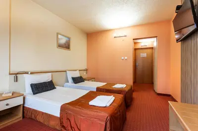 a hotel room with two beds and a television at Hotel Brod - Free Parking in Sofia